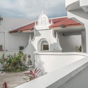 a white house with a staircase leading up to it at Serenity Angkor in Phum Pobos