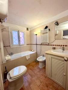 a bathroom with a toilet and a tub and a sink at Comfy in the Heart of Roman nightlife in Rome