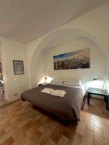 a bedroom with a bed with two towels on it at Comfy in the Heart of Roman nightlife in Rome