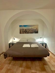 a bedroom with a bed and two tables with towels on it at Comfy in the Heart of Roman nightlife in Rome