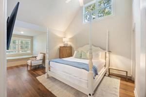 a bedroom with a white bed and a window at SM05: 5 Silver Moss in Kiawah Island +52 photos