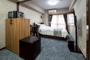 Postel nebo postele na pokoji v ubytování メトロ春日203