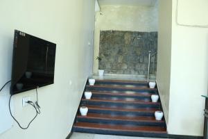 a staircase with a flat screen tv and a television on the wall at Hotel Rangbhawan Kumbhalgarh in Kelwāra
