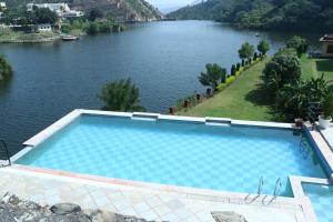 a swimming pool with a view of a river at Hotel Rangbhawan Kumbhalgarh in Kelwāra