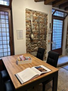 a wooden table with a book on top of it at Taverna La Torre in Bassano del Grappa