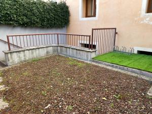 a garden with a bench and grass in front of a building at Taverna La Torre in Bassano del Grappa