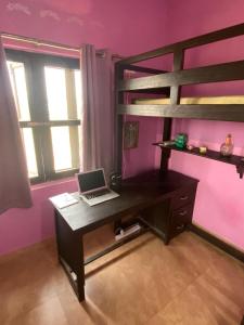 a bedroom with a desk and bunk bed with a laptop at 2 Bedroom furnished flat in Iskcon Mayapur in mayapur +13 photos