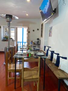 a dining room with a table and a couch at Runa House in Cusco