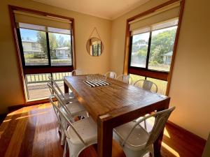 a dining room with a wooden table and chairs at Shelby s Lodge in Evergreen