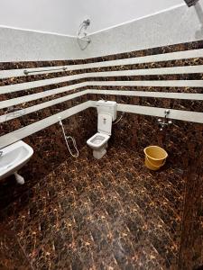 a bathroom with a toilet and a sink at Luxus Resort in Puducherry