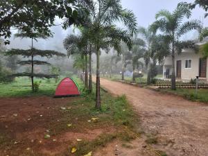a red tent sitting on the side of a dirt road at Holidaypark in Araku