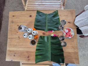 an overhead view of a wooden table with banana leaves at Ekaant Farmstays in Wādhiware