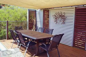 une table et des chaises en bois sur une terrasse dans l'établissement Treetops, à Evergreen