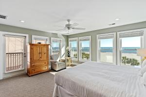 a bedroom with a bed and windows with the ocean at GP132: 132 Grand Pavilion in Isle of Palms +36 photos