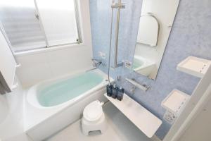 a bathroom with a tub and a toilet and a sink at Kiwaya 貴和家 - Fuji Numazu BASE - in Numazu +80 photos