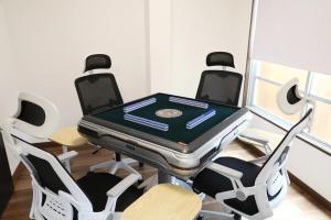 a ping pong table with four chairs around it at Kiwaya 貴和家 - Fuji Numazu BASE - in Numazu