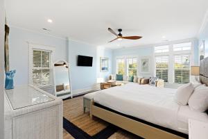 a white bedroom with a bed and a couch at PALM2905: 2905 Palm Blvd. in Isle of Palms
