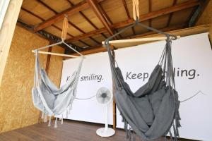 two hammocks hanging from a wall in a room at Kiwaya 貴和家 - Fuji Numazu BASE - in Numazu