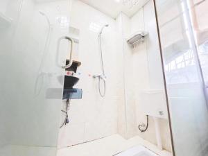 a bathroom with a shower and a toilet at The Cozy Nook in Zhangjiajie
