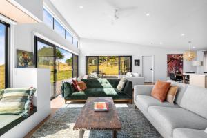 a living room with a couch and a table at Ngurra in Evergreen