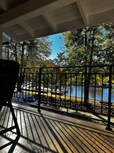 a bench on a porch with a view of a river at Nad Stawem in Ustroń
