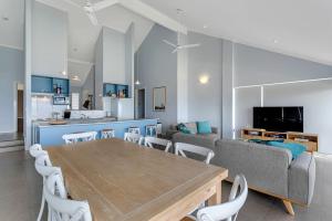 a living room with a table and a couch at 115 Seagull - Beachfront - Wi-Fi - No Linen Included in Hayborough