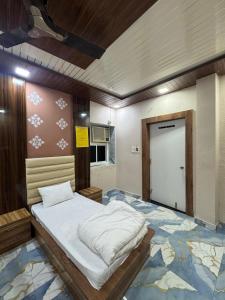 a large bed in a room with a door at Baghdad Palace Near Dargah sharif in Ajmer
