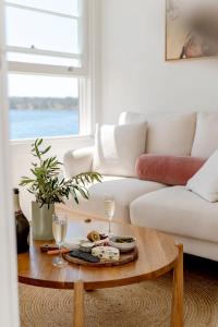a living room with a coffee table and a couch at Fogo @ Ethel & Ode’s in Bundeena