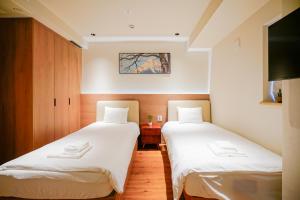 Ένα ή περισσότερα κρεβάτια σε δωμάτιο στο 中野ワールドホテル