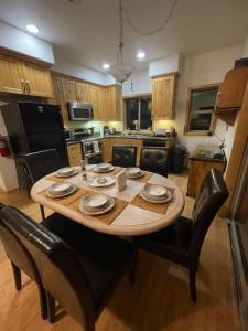 a kitchen with a wooden table and black chairs at Mountainside Family Chalet in Yosemite West
