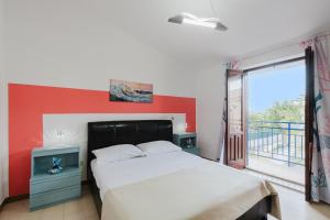 a bedroom with a bed and a large window at Venti Del Mare in Trappeto