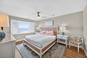 a bedroom with a bed and a window at SG10D: 10D Seagrove Villa in Isle of Palms +32 photos