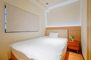 Giường trong phòng chung tại 中野ワールドホテル