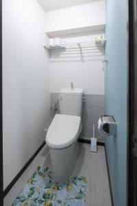 a bathroom with a toilet with a fruit rug on the floor at マンションメゾンV206 maisonV206 in Gifu +20 photos