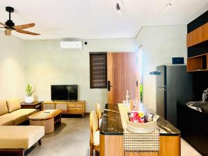 een keuken en woonkamer met een tafel en een bank bij Canggu Bagus Suites in Canggu