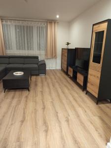 a living room with a couch and a television at Apartmán s 2 spálňami in Prievidza +5 photos