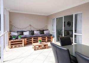 a living room with a couch and a table at Neptunes Hideaway in Jeffreys Bay