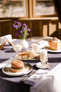 a table with two plates of food and a sandwich at Le Mont in Almaty