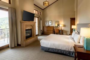 a hotel room with a bed and a fireplace at Hyatt Centric Park City in Park City +112 photos