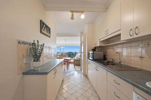 a kitchen with a sink and a counter top at Lovely Unit with Glorious Sea Views in McCracken