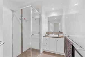 a white bathroom with a shower and a sink at Bluffview B&B - Luxury Oceanviews - Wi-Fi - No Linen Included in McCracken