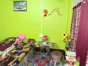 a bedroom with a bed and a desk and a table at Mountain Retreat Ecostay in Kalimpong