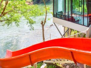 ケーンクラチャンにあるNana River Kaeng Krachanの水の横の赤いベンチ +78枚の写真