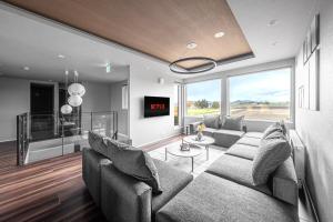 a living room with a couch and a tv at Orvia Yig Villa in Furano