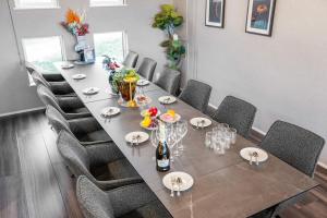 a dining room with a long table and chairs at Orvia Yig Villa in Furano