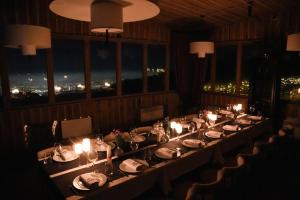 a long table in a restaurant with candles and lights at Le Mont in Almaty +89 photos