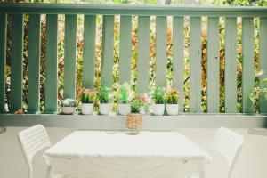a table and chairs on a balcony with potted plants at Tzefania Hotel in Jerusalem