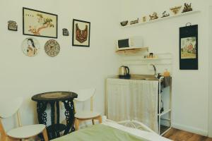 a room with a bed and a table and stools at Tzefania Hotel in Jerusalem