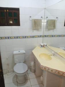 a bathroom with a toilet and a sink at Bosque de Ángeles in Buena Vista +47 photos