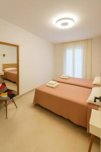 a bedroom with two beds and a mirror at VILLA MAR in Cala'n Bosch +14 photos